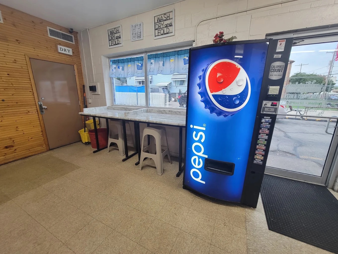 Laundromat entrance with seating and beverage vending