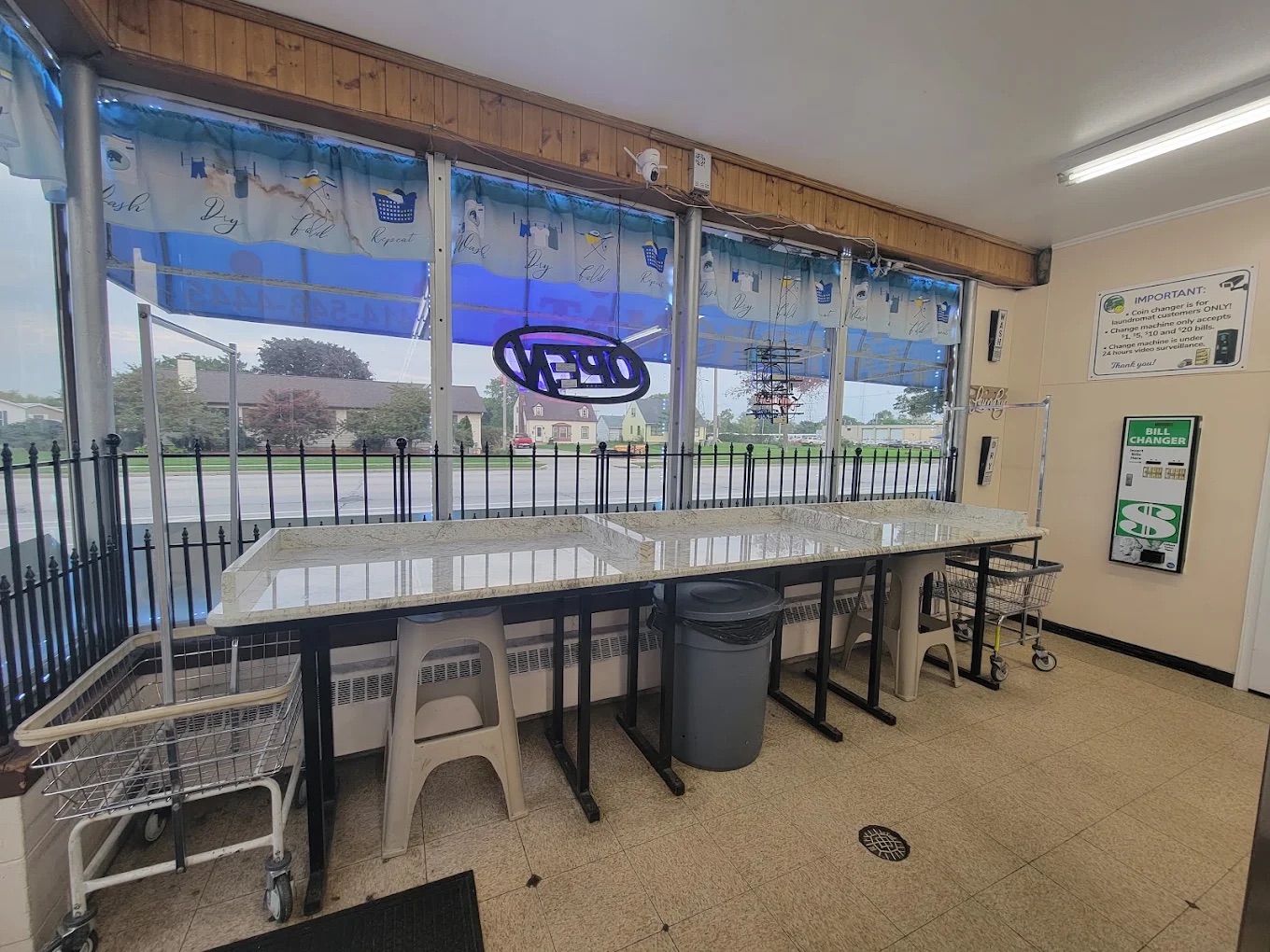 Bright folding counter and laundry carts by the front windows